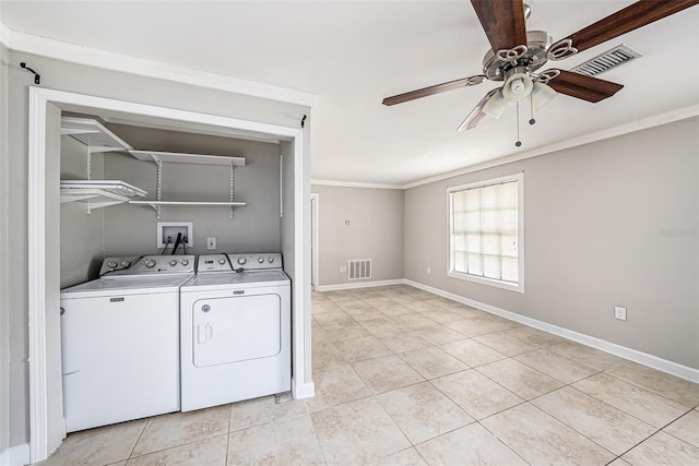 clothes washing area with laundry area, ornamental molding, washing machine and clothes dryer, and visible vents