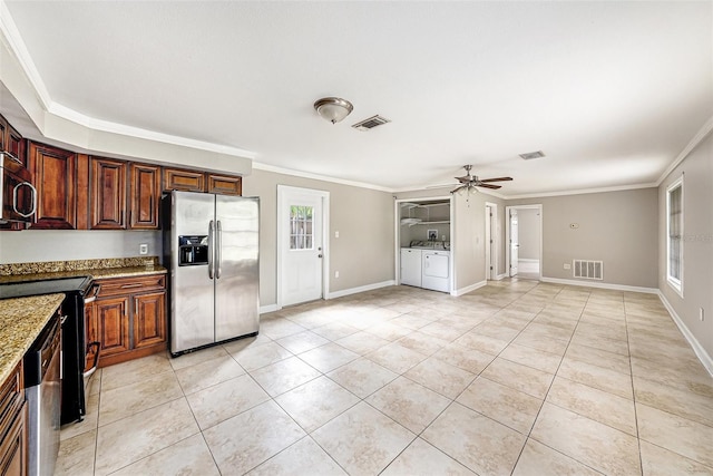 kitchen with appliances with stainless steel finishes, a wealth of natural light, visible vents, and separate washer and dryer