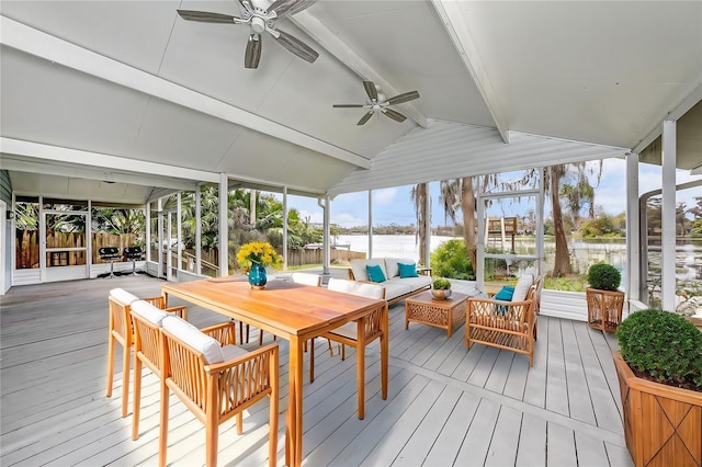 sunroom / solarium featuring lofted ceiling with beams and ceiling fan