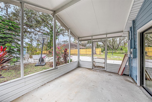 unfurnished sunroom with vaulted ceiling