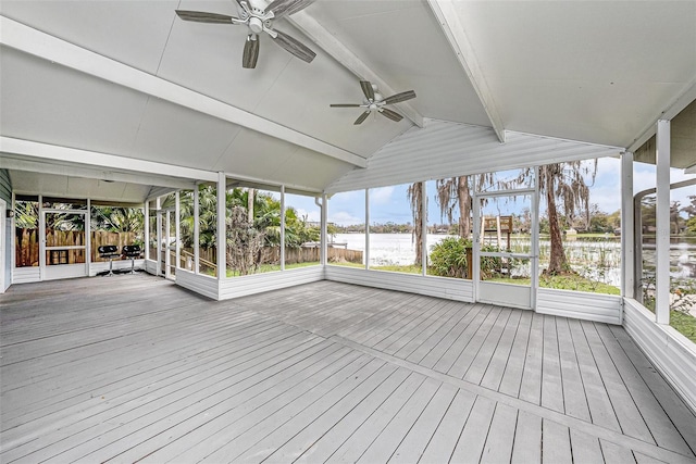 unfurnished sunroom featuring lofted ceiling with beams and a ceiling fan