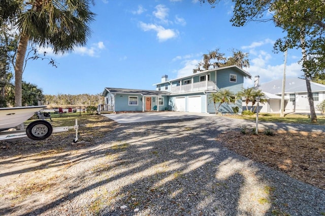 view of front of property featuring a balcony and a garage