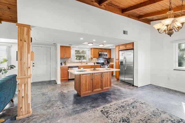 kitchen with wood ceiling, decorative light fixtures, an island with sink, stainless steel appliances, and beam ceiling