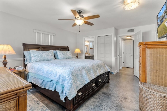 bedroom featuring connected bathroom, concrete flooring, a closet, and ceiling fan