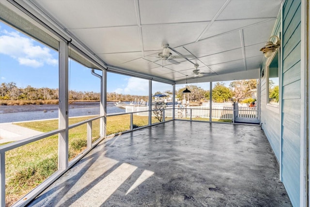 unfurnished sunroom with ceiling fan and plenty of natural light