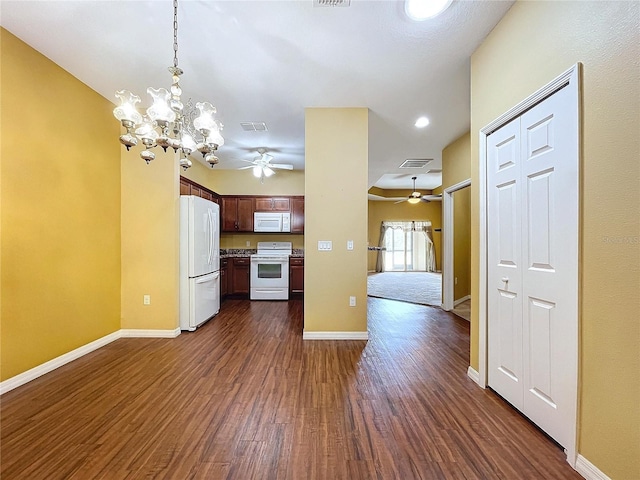 kitchen featuring white appliances, ceiling fan with notable chandelier, decorative light fixtures, and dark hardwood / wood-style floors