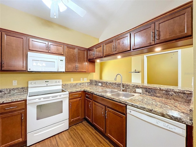 kitchen with vaulted ceiling, sink, light wood-type flooring, ceiling fan, and white appliances