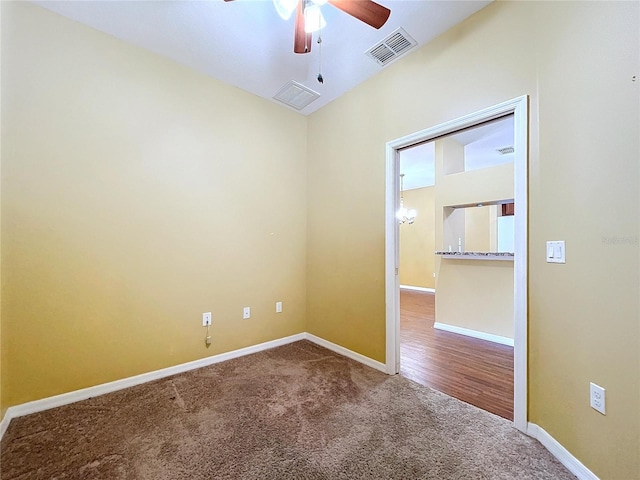 unfurnished room with ceiling fan and carpet flooring