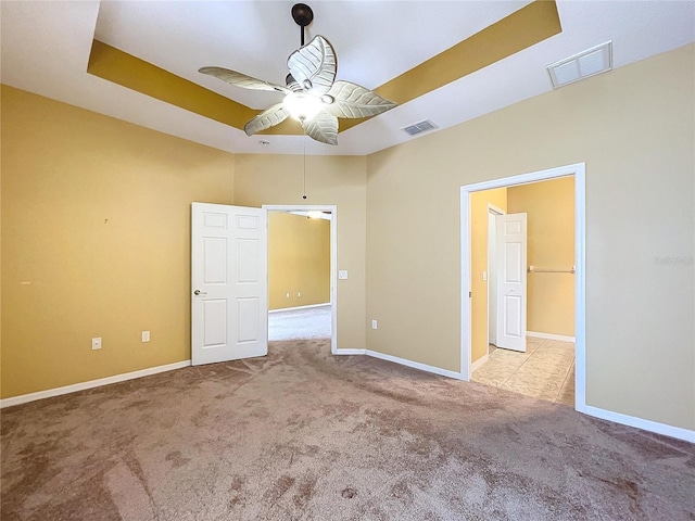 unfurnished bedroom with light colored carpet and ceiling fan