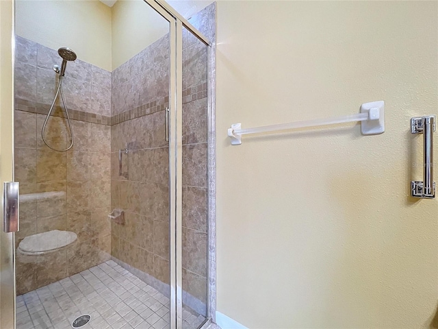 bathroom with a shower with door