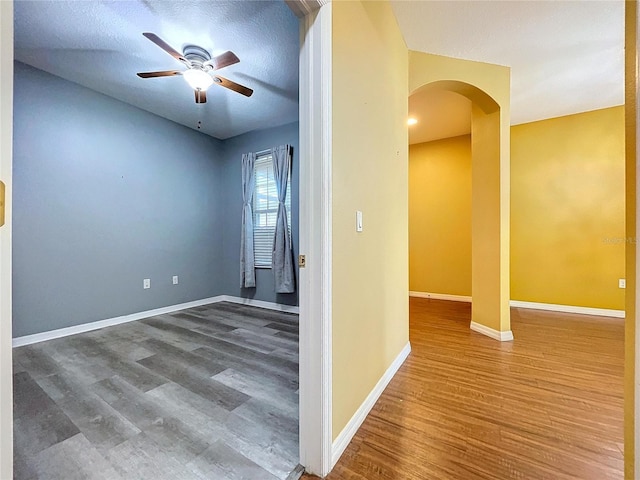 interior space with ceiling fan, hardwood / wood-style floors, and a textured ceiling