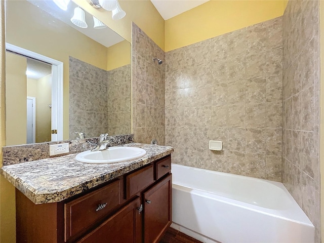 bathroom with vanity and tiled shower / bath combo