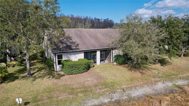 back of house featuring a sunroom and a yard