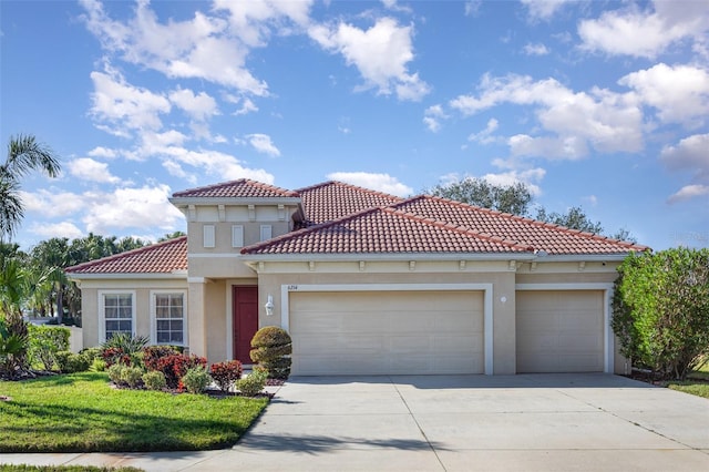 mediterranean / spanish-style house with stucco siding, a front lawn, a tile roof, concrete driveway, and a garage