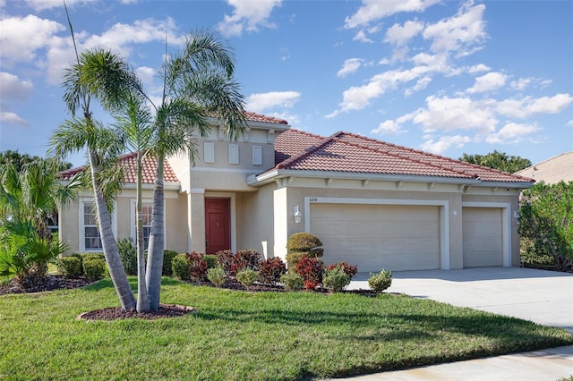 mediterranean / spanish-style home featuring a tiled roof, concrete driveway, a front yard, stucco siding, and an attached garage