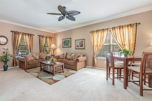 living area with crown molding, light colored carpet, and baseboards