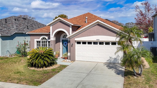 view of front of property with a garage and a front lawn