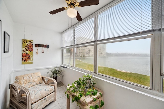 sunroom with a water view and ceiling fan