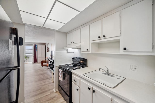 kitchen featuring white cabinetry, sink, and black appliances