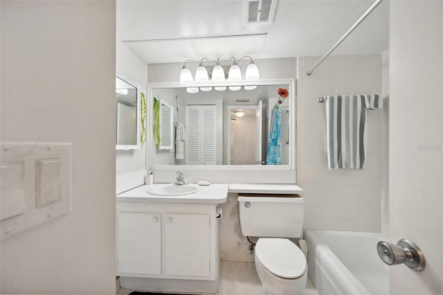 full bathroom featuring vanity, tiled shower / bath, and toilet