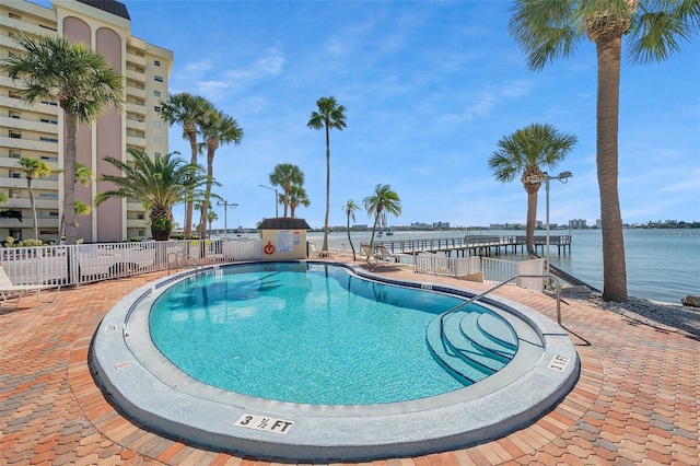 view of swimming pool with a water view