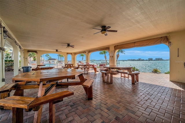 view of patio / terrace with a water view and ceiling fan