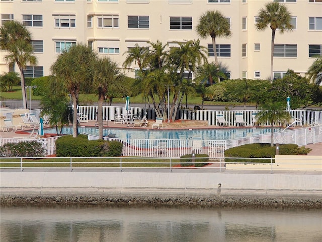 view of swimming pool featuring a water view