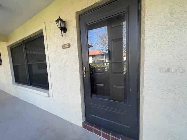 doorway to property with stucco siding