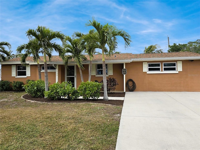 ranch-style home with a front lawn