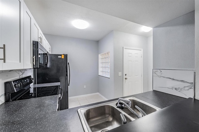 kitchen with sink, black electric range, a textured ceiling, and white cabinets