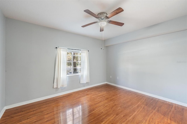 spare room with hardwood / wood-style flooring and ceiling fan