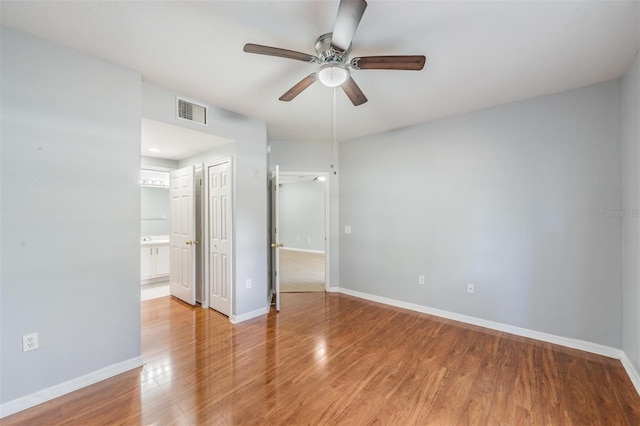 empty room featuring ceiling fan and hardwood / wood-style floors