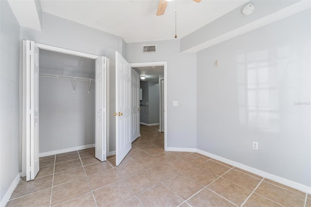 unfurnished bedroom featuring a closet, ceiling fan, and light tile patterned flooring