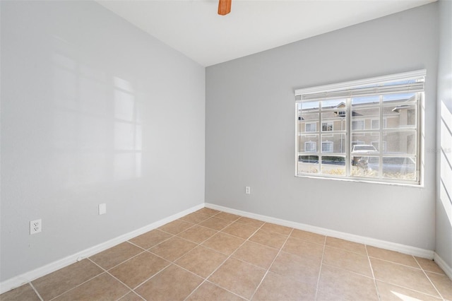 empty room featuring ceiling fan and light tile patterned flooring