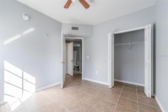 unfurnished bedroom featuring light tile patterned floors, a closet, and ceiling fan