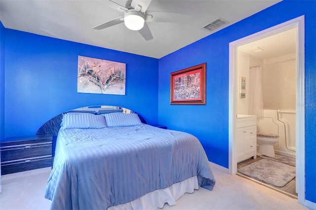 carpeted bedroom featuring ensuite bathroom and ceiling fan