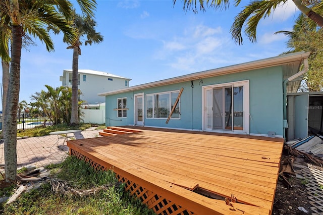 back of house with a patio area, fence, a deck, and stucco siding