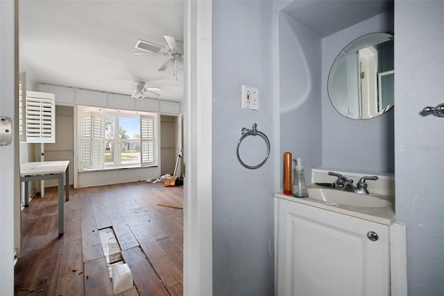 bathroom featuring wood-type flooring, vanity, and a ceiling fan