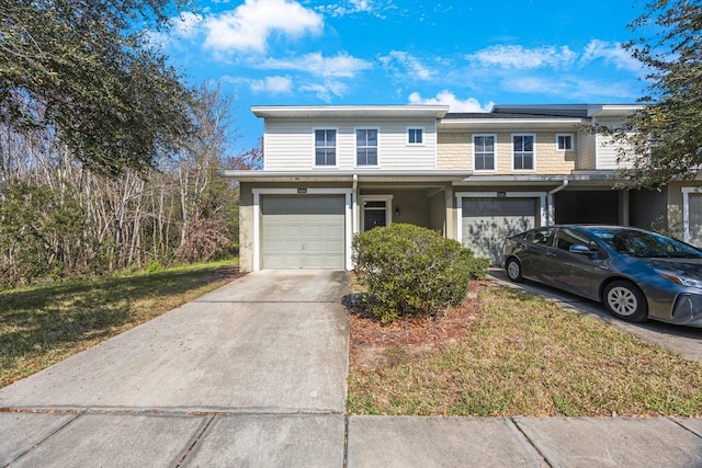 view of front facade featuring a garage and a front yard