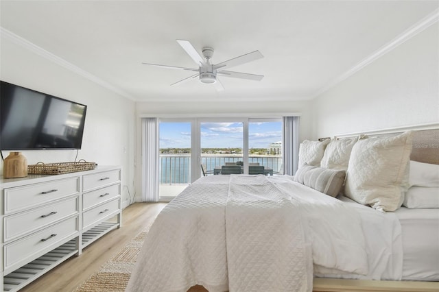 bedroom featuring access to exterior, ornamental molding, light hardwood / wood-style floors, and a water view