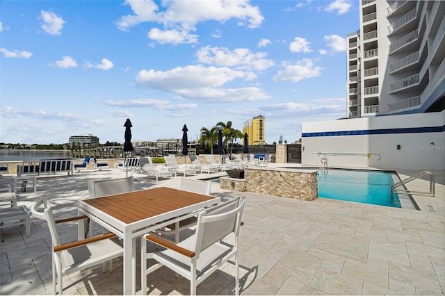 view of patio featuring a community pool and a water view