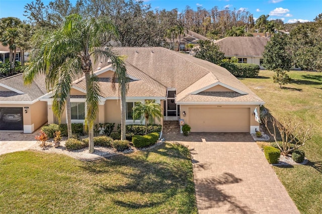 view of front facade with a garage and a front lawn