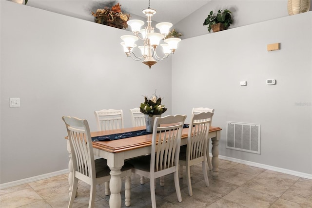 dining area featuring an inviting chandelier and lofted ceiling