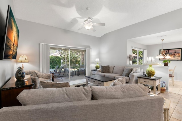 tiled living room with ceiling fan and vaulted ceiling