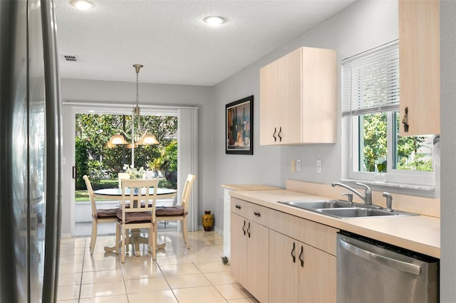 kitchen featuring pendant lighting, sink, stainless steel appliances, and light brown cabinetry