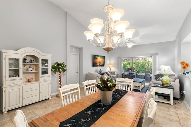 dining area featuring lofted ceiling, a chandelier, and light tile patterned flooring