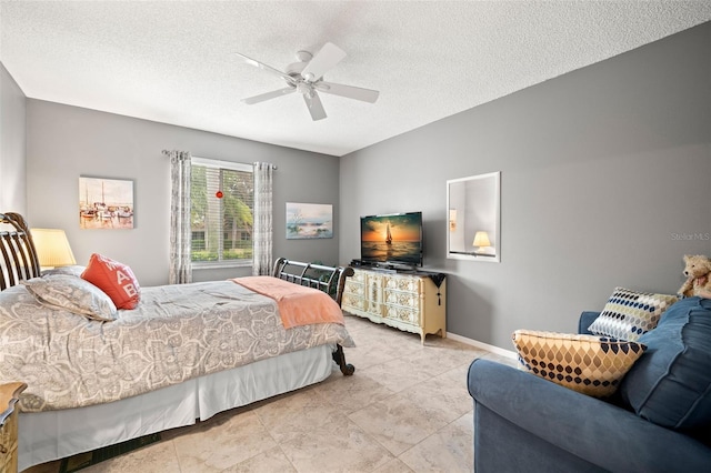 bedroom featuring ceiling fan and a textured ceiling