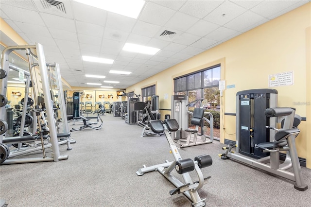 exercise room with a paneled ceiling