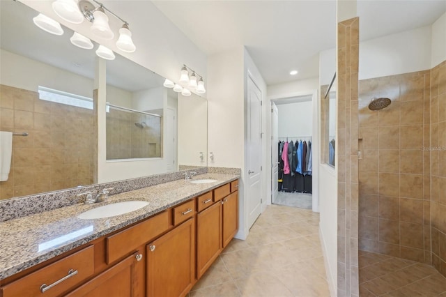 7580 Pool Compass Loop, Wesley Chapel, FL 33545 - bathroom featuring a sink, a walk in shower, tile patterned flooring, and double vanity