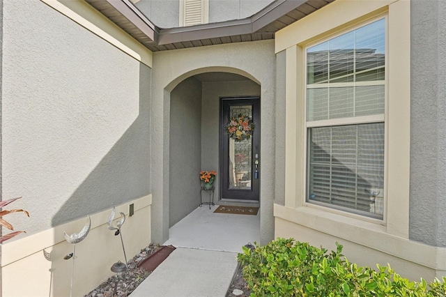 7580 Pool Compass Loop, Wesley Chapel, FL 33545 - doorway to property with stucco siding